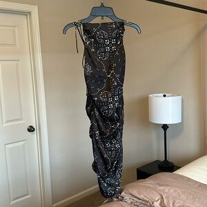 Black, backless mini dress with adjustable tie straps.